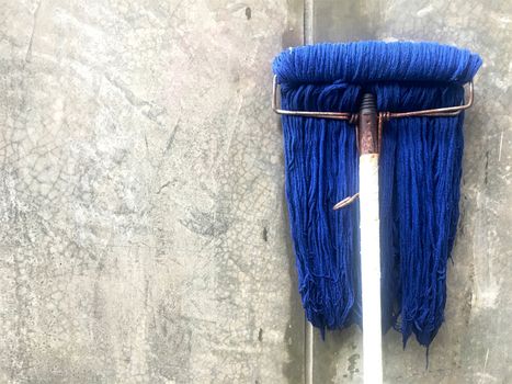 Dirty blue mop after cleaning the house.