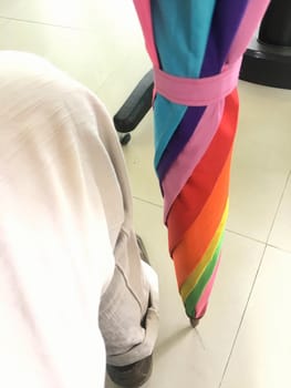 Rainbow umbrella on the left leg