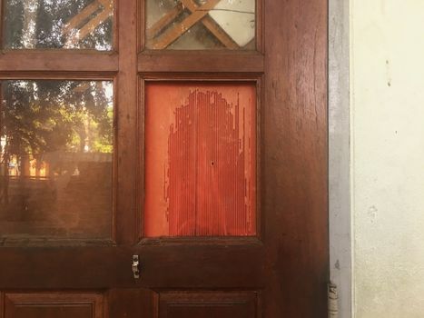 The glass door cracked and the red plastic sheet came off.