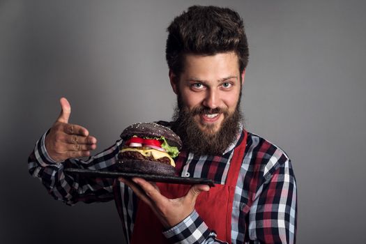 Man pointing at fresh self made burger close up