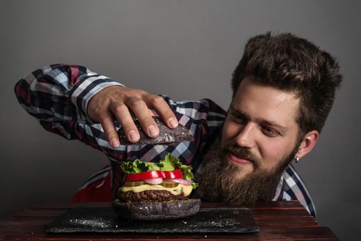 Man cooking fresh self made burger close up