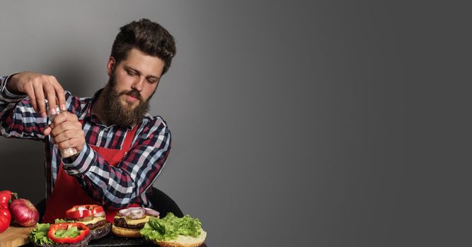 Man cooking fresh self made burgers close up