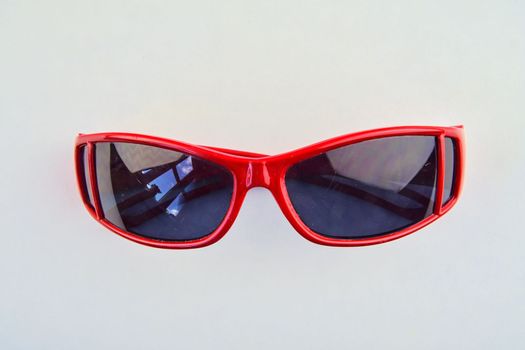 Stylish red sunglasses for children. Eye glasses on white background.