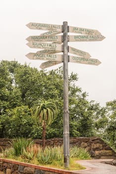 A signpost, showing the distances to famous waterfall of the world, at the Howick Falls, in Howick, in the Kwazulu-Natal Midlands Meander