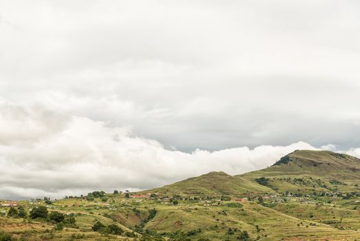 A mountain landscape with the Nkumba township between Boston and Bulwer in the Kwazulu-Natal Province of South Africa