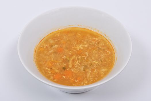 Groat soup with vegetables on a white background