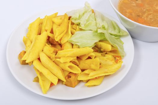 Baked pasta with curry on a white background