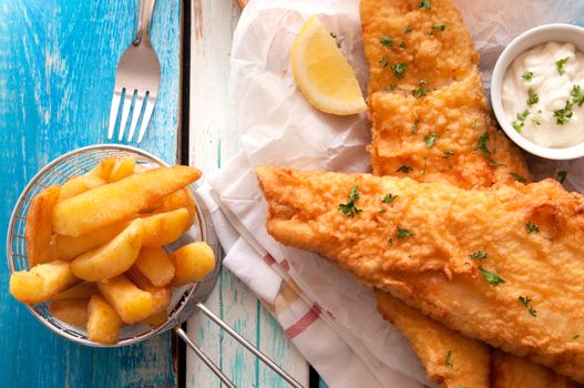 Close up battered fish and chips with mayonnaise sauce