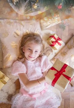 Top view of smiling female kid with lots of presents