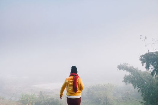 woman standing among mist to freedom