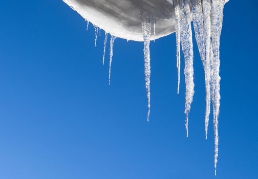 Hanging icicles with a blue sky background