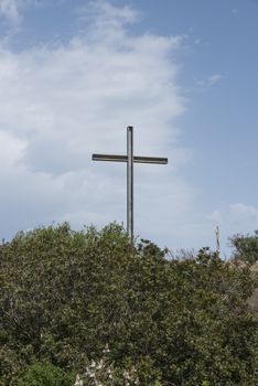 metal cross on a hill on the island of sardinia  italy