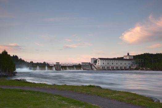 Rånåsfoss dam and power station in Akershus, Norway. Water is flowing over the dam. Long exposure.