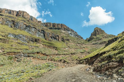 The hairpin bends in the Sani Pass. Four-wheel drive vehicles are visible in the back