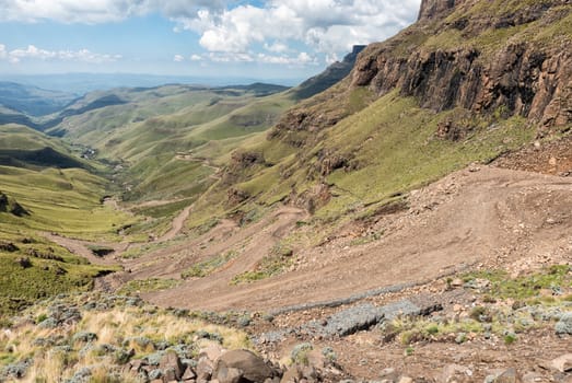The hairpin bends in the Sani Pass. Four-wheel drive vehicles are visible on the pass