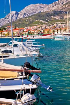 Colorful Makarska boats and waterfront under Biokovo mountain view, Dalmatia region of Croatia