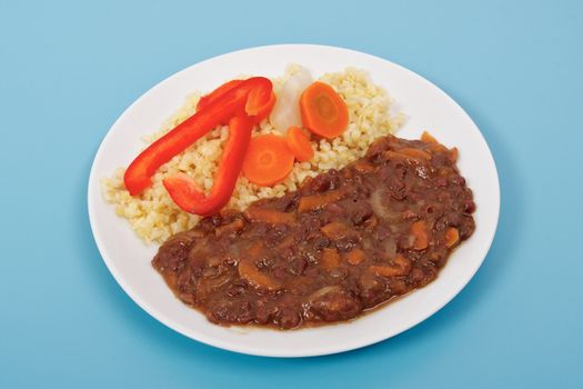 Azuki with vegetables on steam and bulgur on a blue background