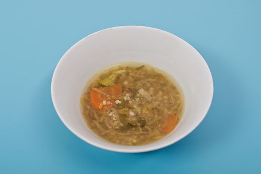 Miso vegetable soup with vegetables on a blue background