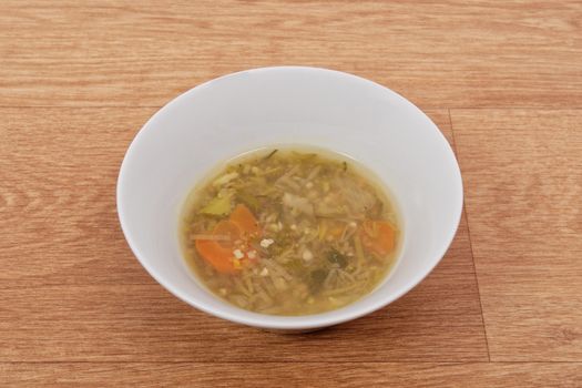 Miso vegetable soup with vegetables on a wooden table