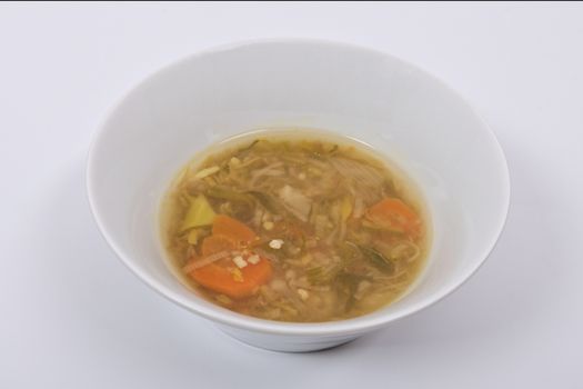 Miso vegetable soup with vegetables on a white background