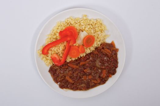 Azuki with vegetables on steam and bulgur on a white background