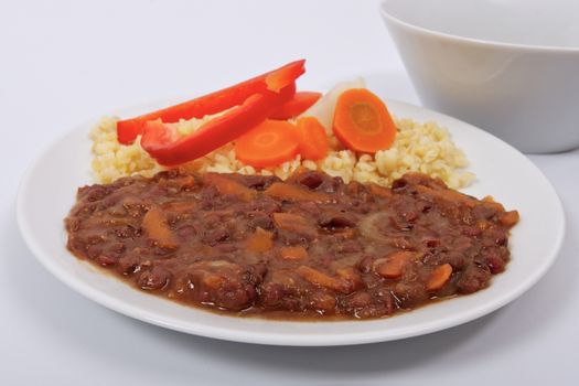 Azuki with vegetables on steam and bulgur on a white background