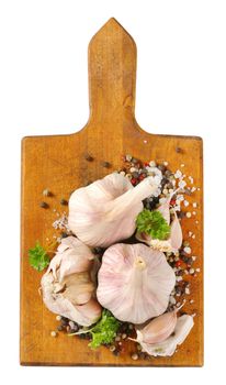 fresh garlic with spices on wooden cutting board