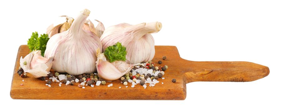 fresh garlic with spices on wooden cutting board