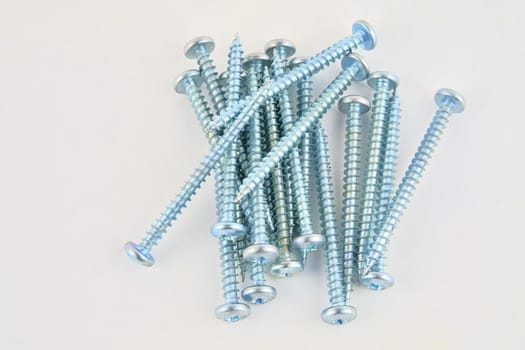 Set of screws for construction on a white background, metal screw, iron screw, chrome screw, screws as a background, wood screw. Close-up.