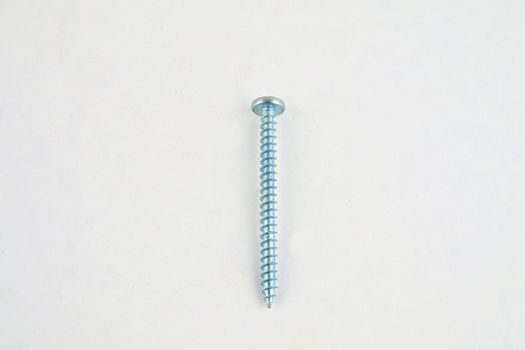 Screw for construction on a white background, metal screw, iron screw, chrome screw, screw as a background, wood screw. Close-up.