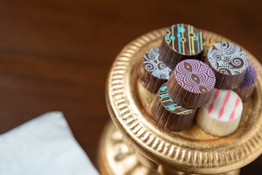 Artisan Fine Chocolate Candy On Gold Pillar Serving Dish.