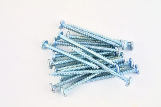 Screws for construction on a white background, metal screw, iron screw, chrome screw, screws as a background, wood screw. Close-up.