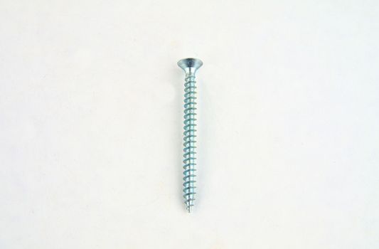 Screw for construction on a white background, metal screw, iron screw, chrome screw, screw as a background, wood screw. Close-up.