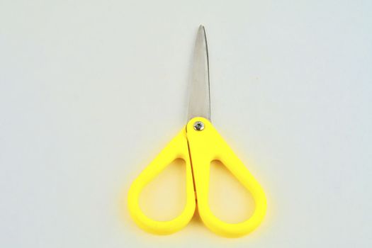 Yellow scissors isolated on a white background. Flat design. Top view.