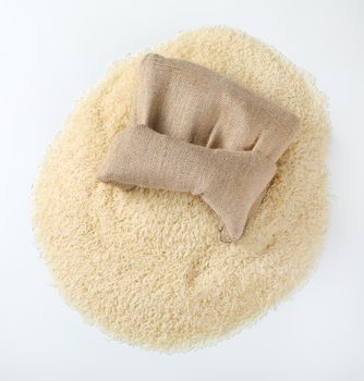 white rice spilling out of burlap bag