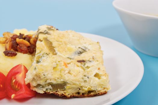 Baked leek with mashed potatoes on a blue background