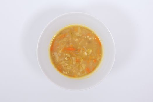 Soup with pasta and vegetables on a white background