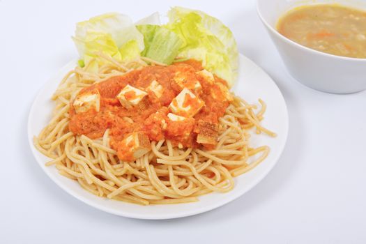 Bolognese spaghetti with tofu on a white background