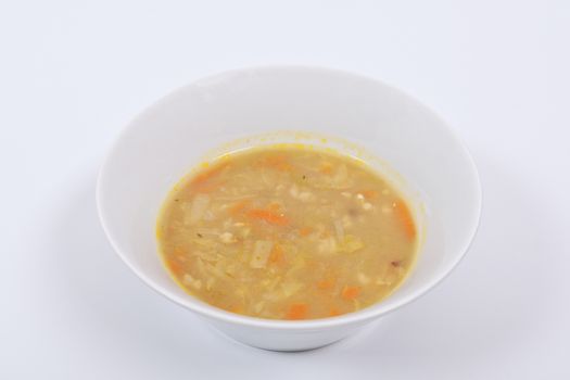 Soup with pasta and vegetables on a white background