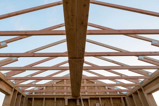 Roof support beams and wood studs framing in new home construction