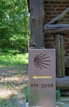 Milestone or signpost with arrow and jacobs shell