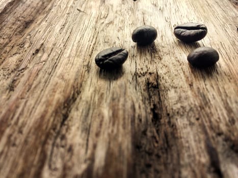 Fresh coffee beans on wood background