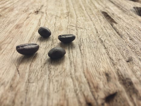 Fresh coffee beans on wood background