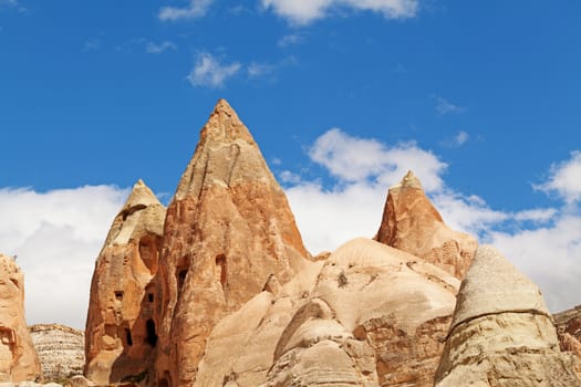 Cylindrical stone cliffs and cave houses near Goreme, Turkey