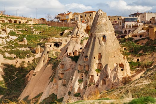 Stone cliffs and cave houses in Uchisar near Goreme, Turkey