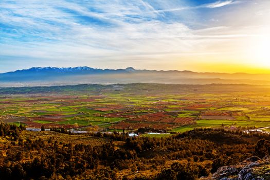 Aerial view of beutiful sunset over green and red agricultiral fields near Pamukkale in Turkey