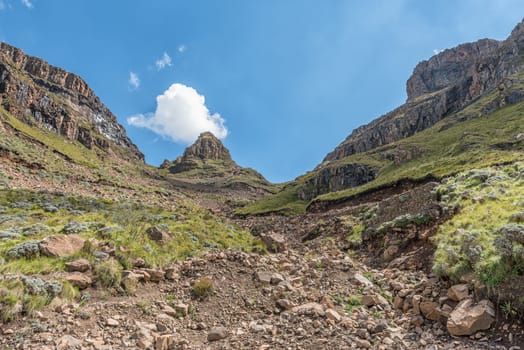 The hairpin bends in the Sani Pass. A four-wheel drive vehicle is visible in the back
