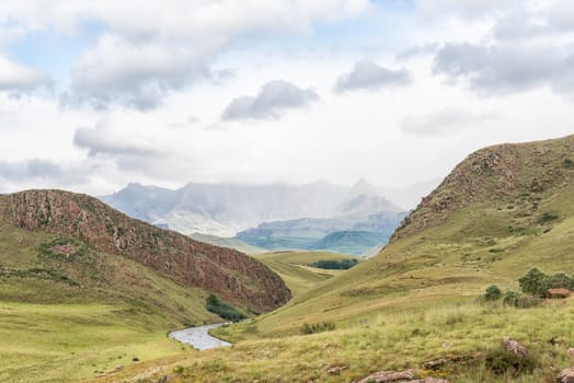 The landscape on road-P317 to Garden Castle in the Drakensberg near Underberg. Rhino Peak (3056m) is visible in the back and the Umzimkulu River in front
