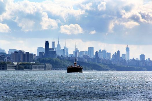 Boat on the move on East River against Brooklyn view in New York City, NY, USA