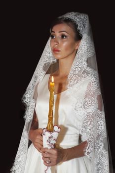 The beautiful bride on wedding ceremony in the Russian Church. Moscow
